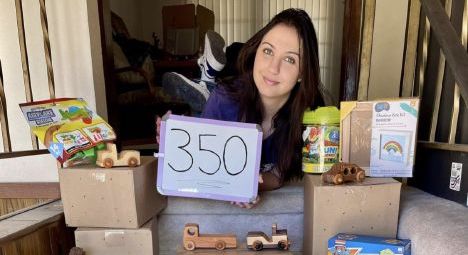 Sarah Pugliese poses with items ready to go in her Topaz Fairy boxes. To date, she has mailed out 357 boxes to kids in 45 states.