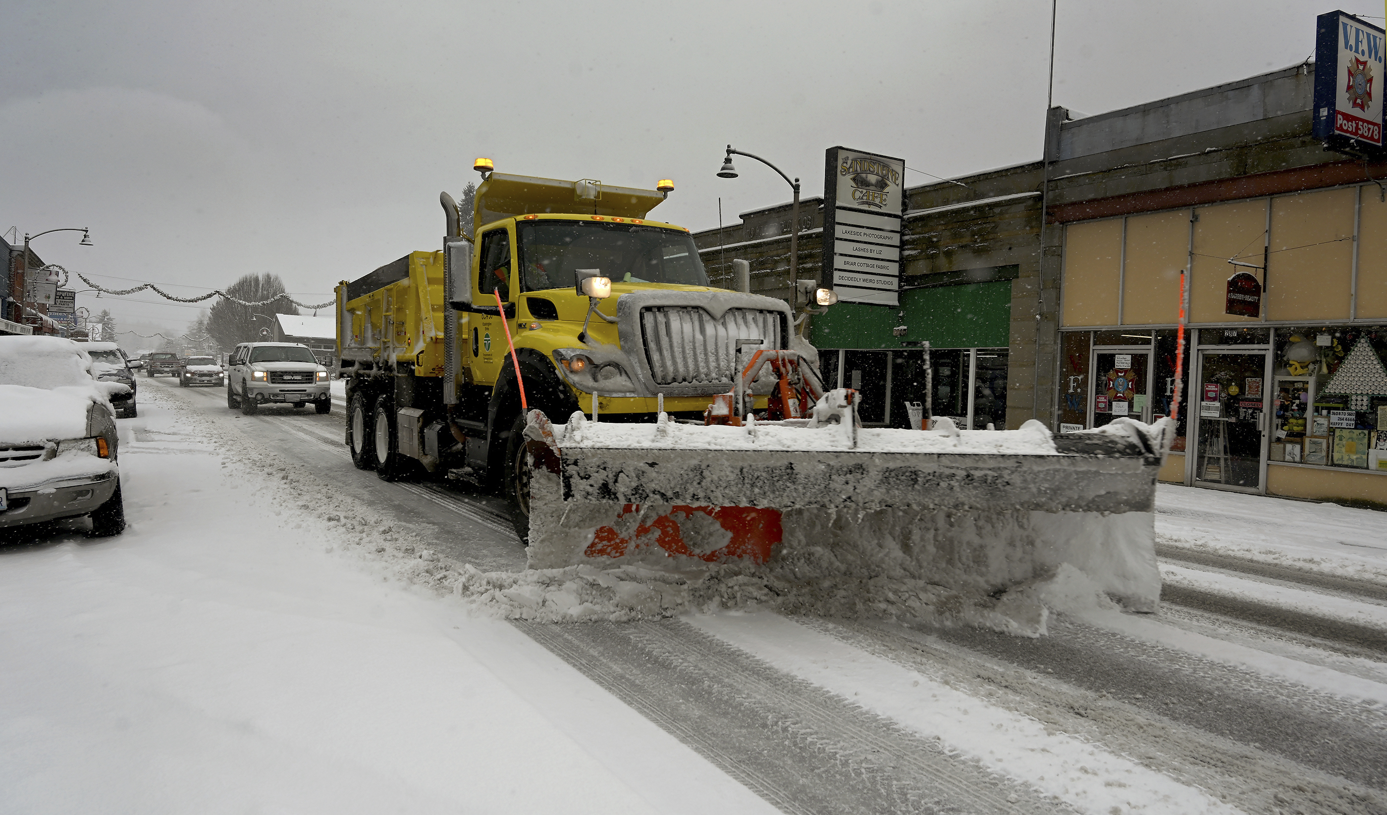A snow plow travels down a street in Tenino, Wash. on Sunday, Dec. 26, 2021. Several inches of snow fell overnight in the south sound area which made traveling a challenge on many parts of Thurston County. 
