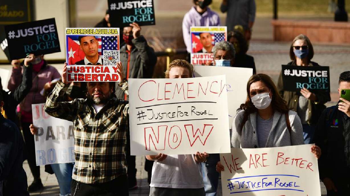 People hold signs in support of truck driver Rogel Aguilera-Mederos during a rally on the west steps of the state capitol Wednesday in Denver.