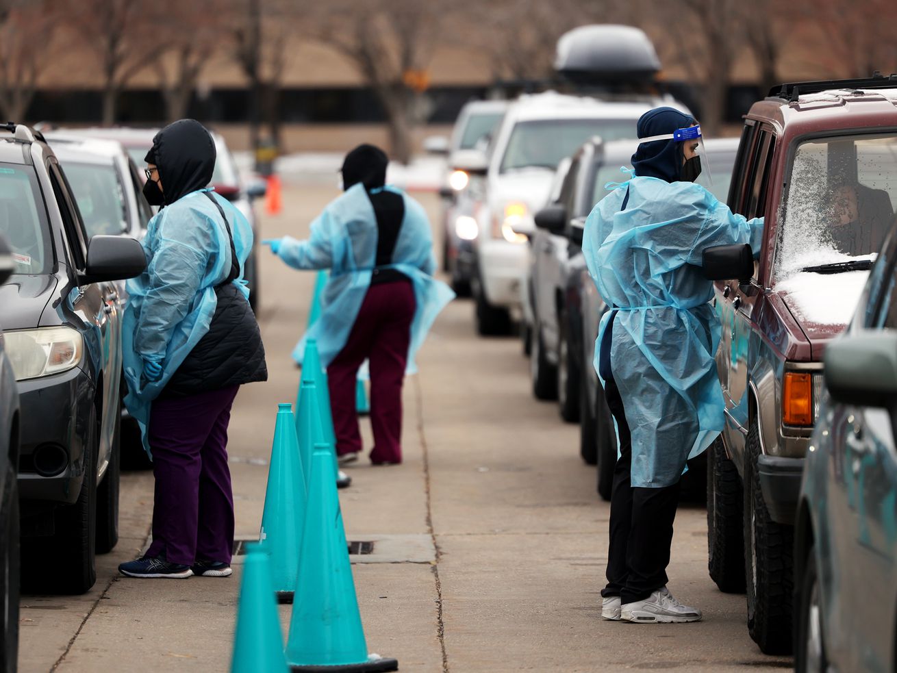 People in a long line of cars wait to be tested for COVID-19 by NOMI Health personnel outside of the Utah Department of
Health in Salt Lake City on Monday.