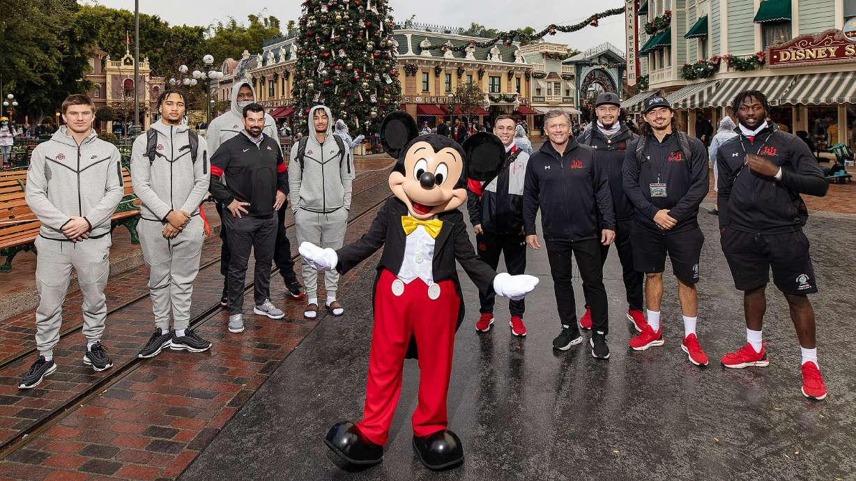 Utah Utes and Ohio State Buckeyes pose for a photo at Disneyland in Anaheim on Monday, Dec. 27, 2021, as part of events leading up to the Rose Bowl.