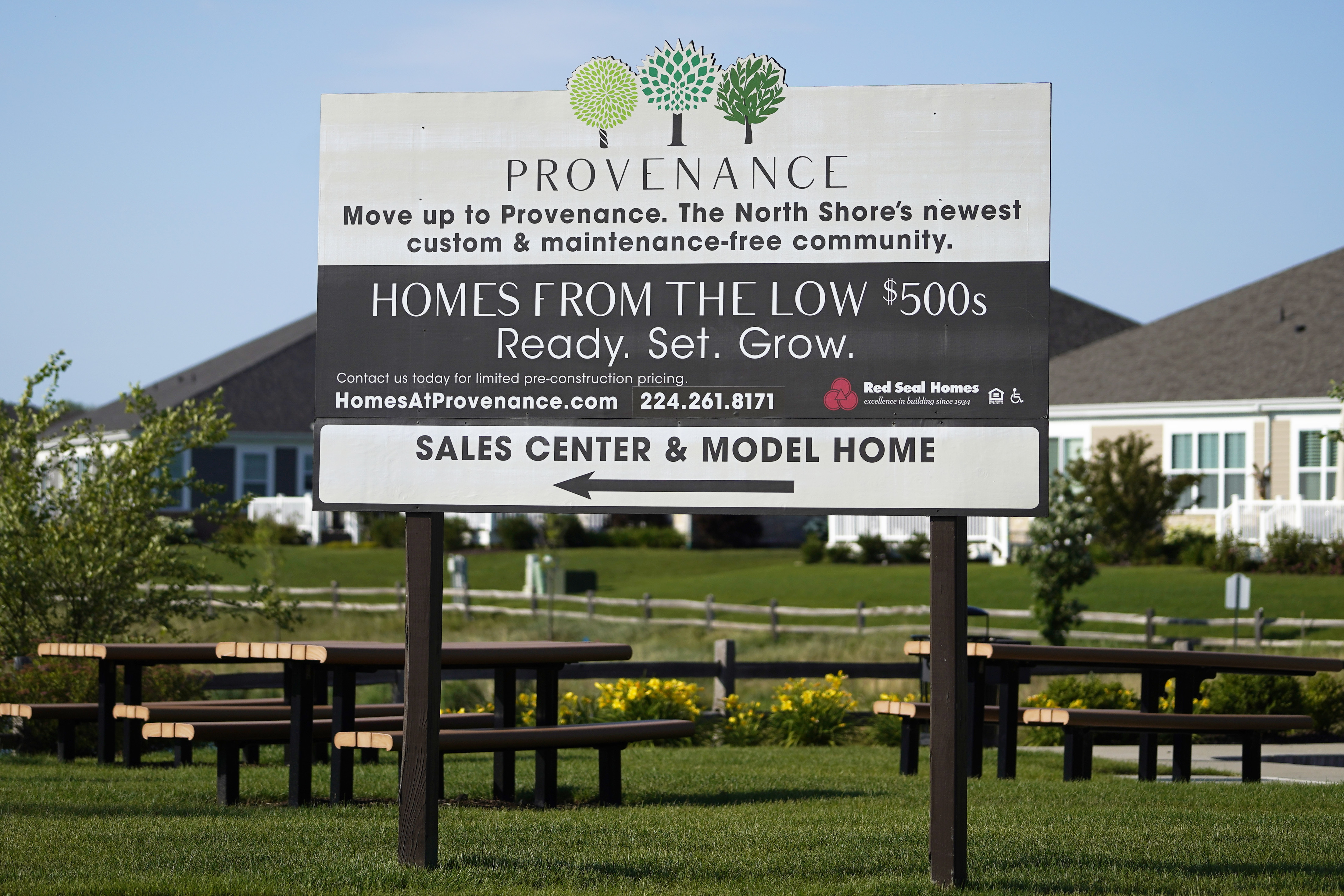 A homes sale sign is shown in Northbrook, Ill., June 23. U.S. home prices surged again in October.