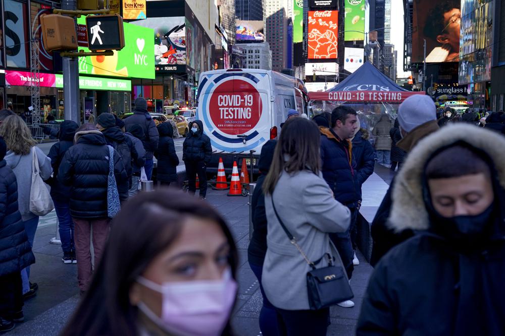 People wait in a long line to get tested for COVID-19 in Times Square, New York, Dec. 20. New isolation and quarantine guidelines draw criticism from some medical experts.