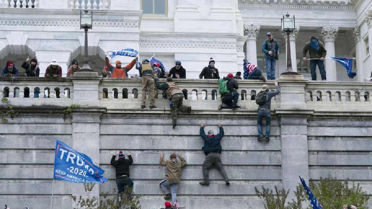 Violent insurrectionists loyal to then-President Donald Trump climb the west wall of the U.S. Capitol in Washington, Jan. 6. On Tuesday, the Jan. 6 committee agreed to shield some documents.