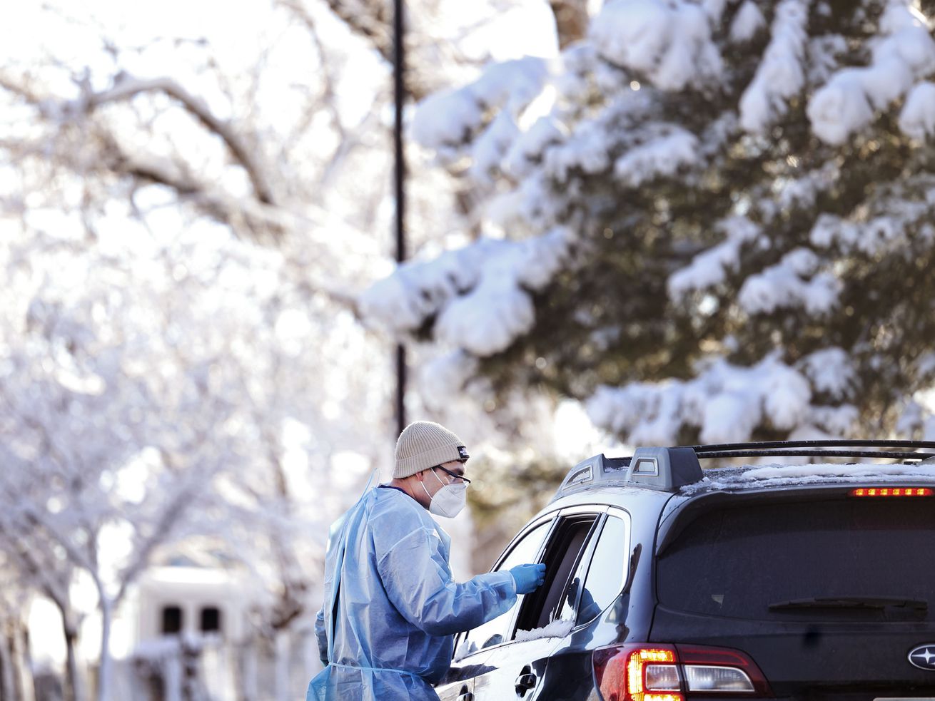 Javanni Alzayyat administers a COVID-19 test at the Cannon Health Building in Salt Lake City on Dec. 15. Utah health officials on New Year's Eve announced an "unofficial" daily record for new COVID-19 cases, with preliminary data showing about 4,700 new cases.