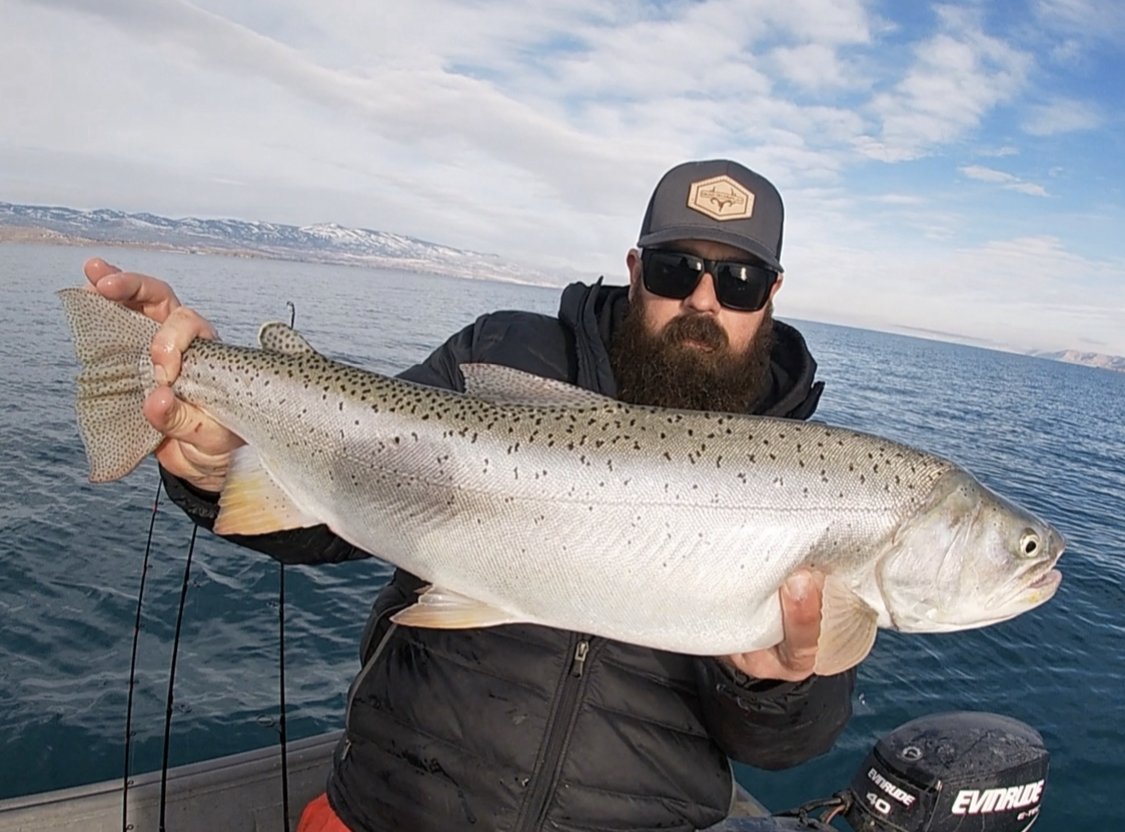 Travis Hobbs holds a Bear Lake cutthroat trout he caught at Bear Lake on Jan. 17. The fish broke the previous record by 3.5 inches in length.