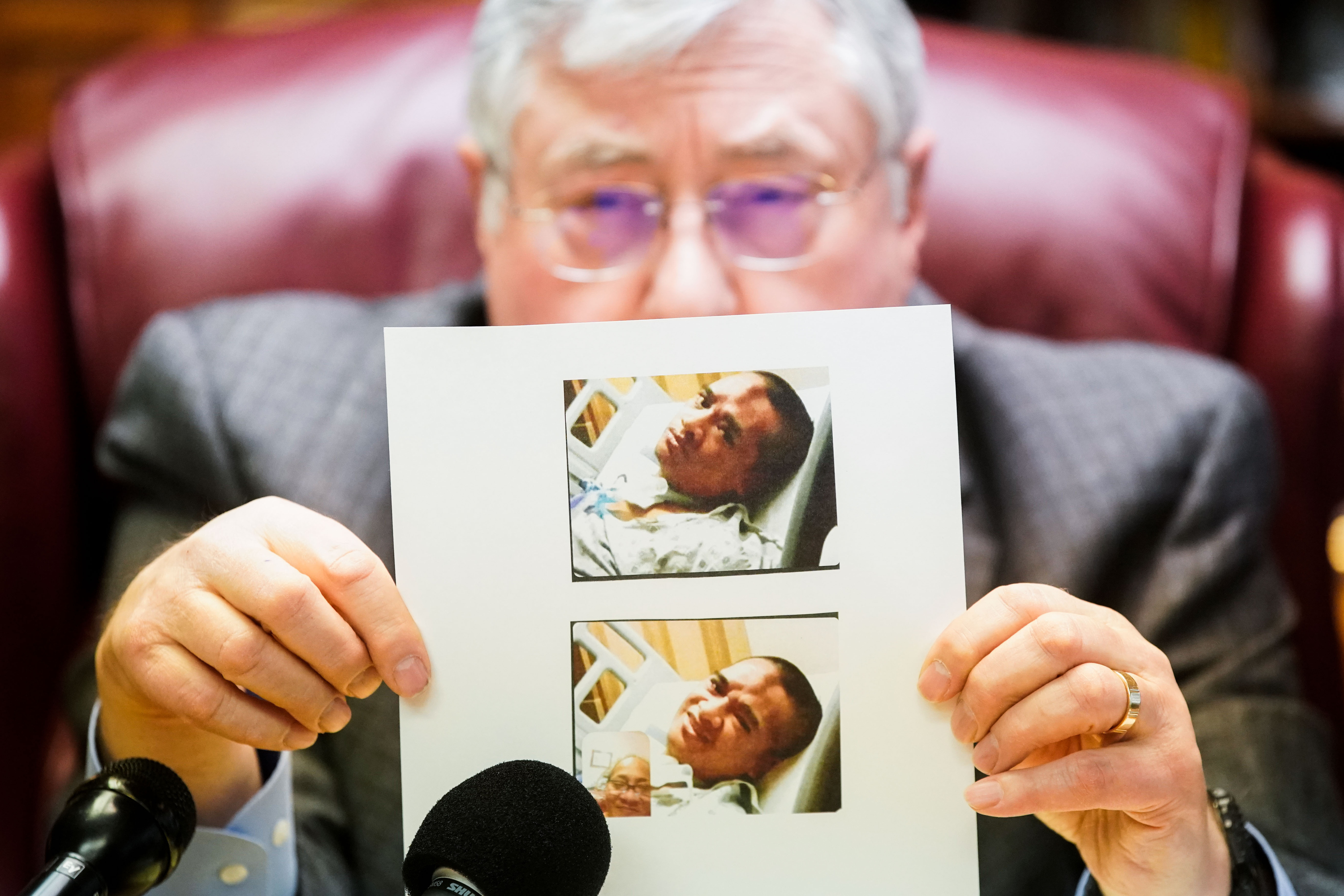 Lawyer Robert B. Sykes shows a recent photograph of Atonio Sivatia, taken in the hospital, during a press conference in Salt Lake City on Tuesday. Sivatia suffered permanent debilitating injuries when he was run over by a car while being arrested by West Valley police. He is now suing the officers involved.