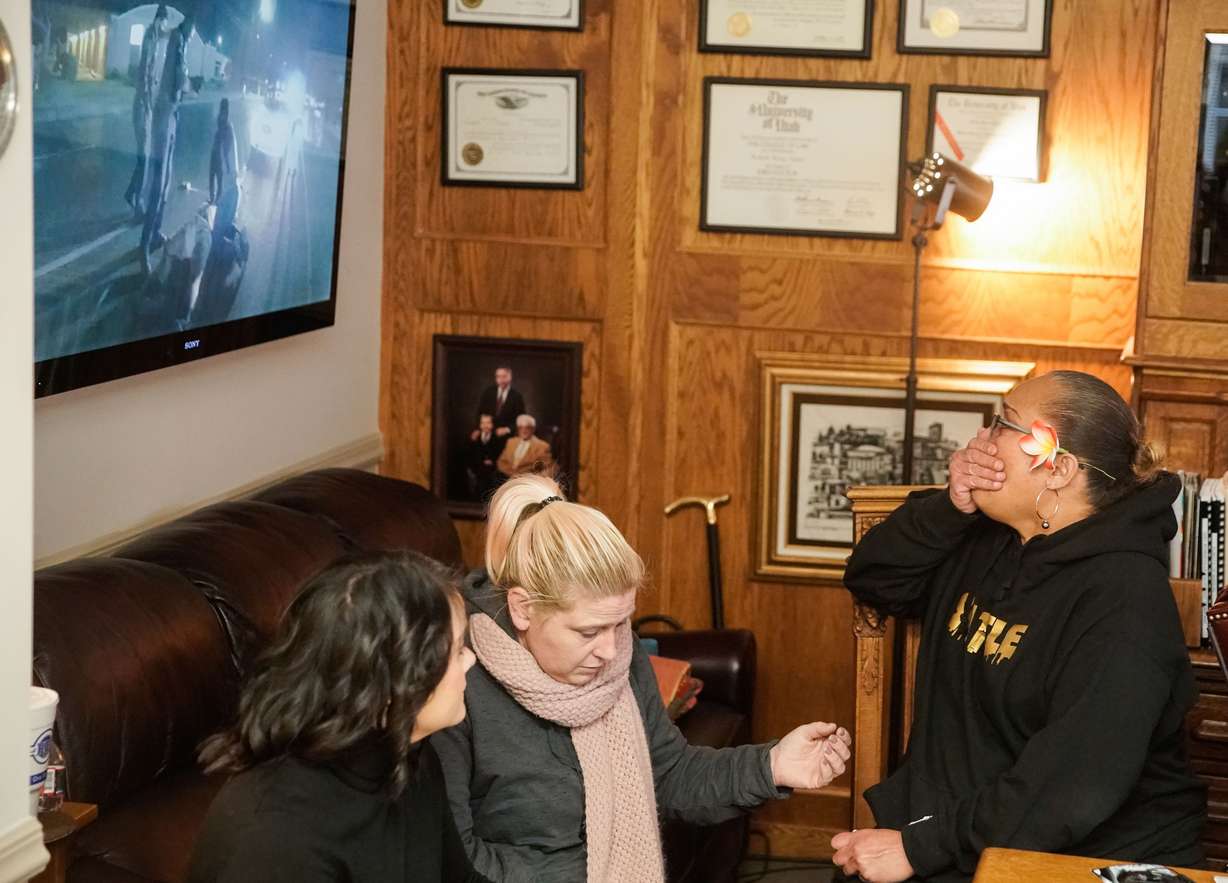 Attorney Christina Isom, left, and Kristie Sanchez, center, sit next to Sanchez's sister, Nonnie Masaniai, as Masaniai watches body-cam video of her son, Atonio Sivatia, during a press conference in Salt Lake City on Tuesday. Sivatia suffered permanent debilitating injuries when he was run over by a car while being arrested by West Valley police. He is now suing the officers involved.