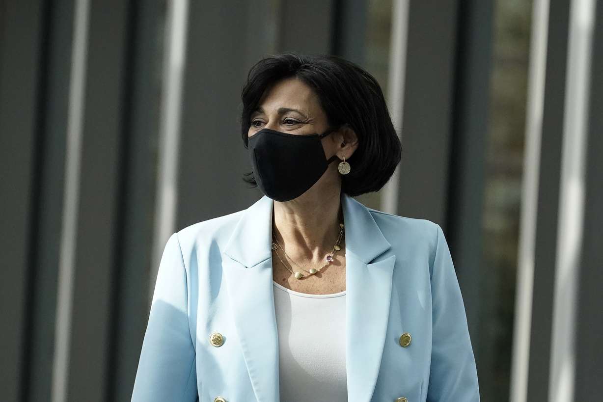Dr. Rochelle Walensky, director of the U.S. Centers for Disease Control and Prevention, walks during an interview with The Associated Press on Dec. 8, 2021, in Atlanta. Walensky said the CDC is contemplating a change to its mask guidance in the coming weeks.