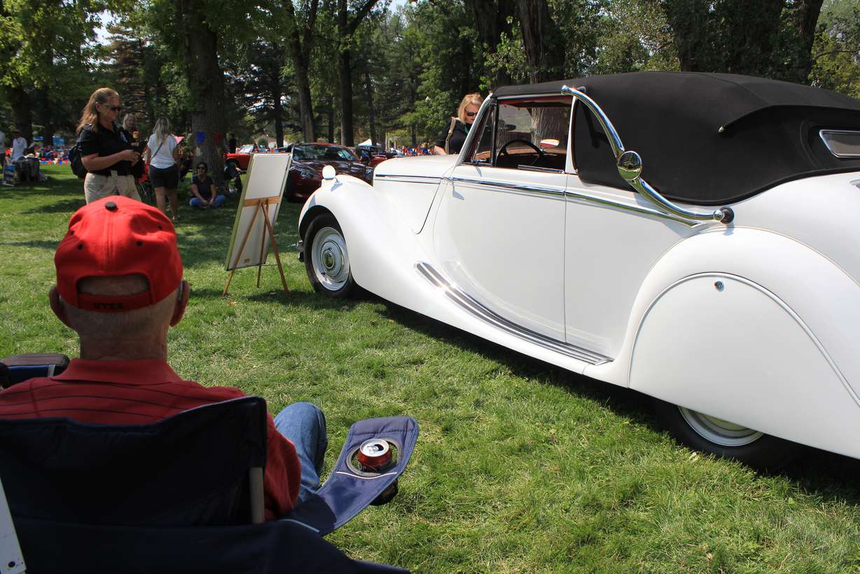 Art Pasker watches a fan learn about his 1950 Jaguar at British Field Day on Aug. 28, 2021, at Liberty Park in Salt Lake City.