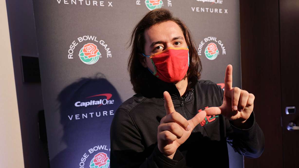 Utah Utes quarterback Cameron Rising flashes a “U” to reporters during a press conference in Los Angeles on Tuesday, Dec. 28, 2021, about the upcoming Rose Bowl.