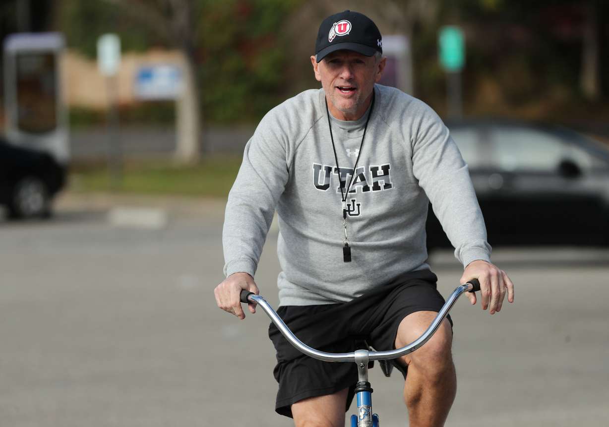 Utah Utes head coach Kyle Whittingham bikes to a field for practice for the upcoming Rose Bowl game against Ohio State at Dignity Health Sports Park in Carson, Calif., on Tuesday, Dec. 28, 2021.