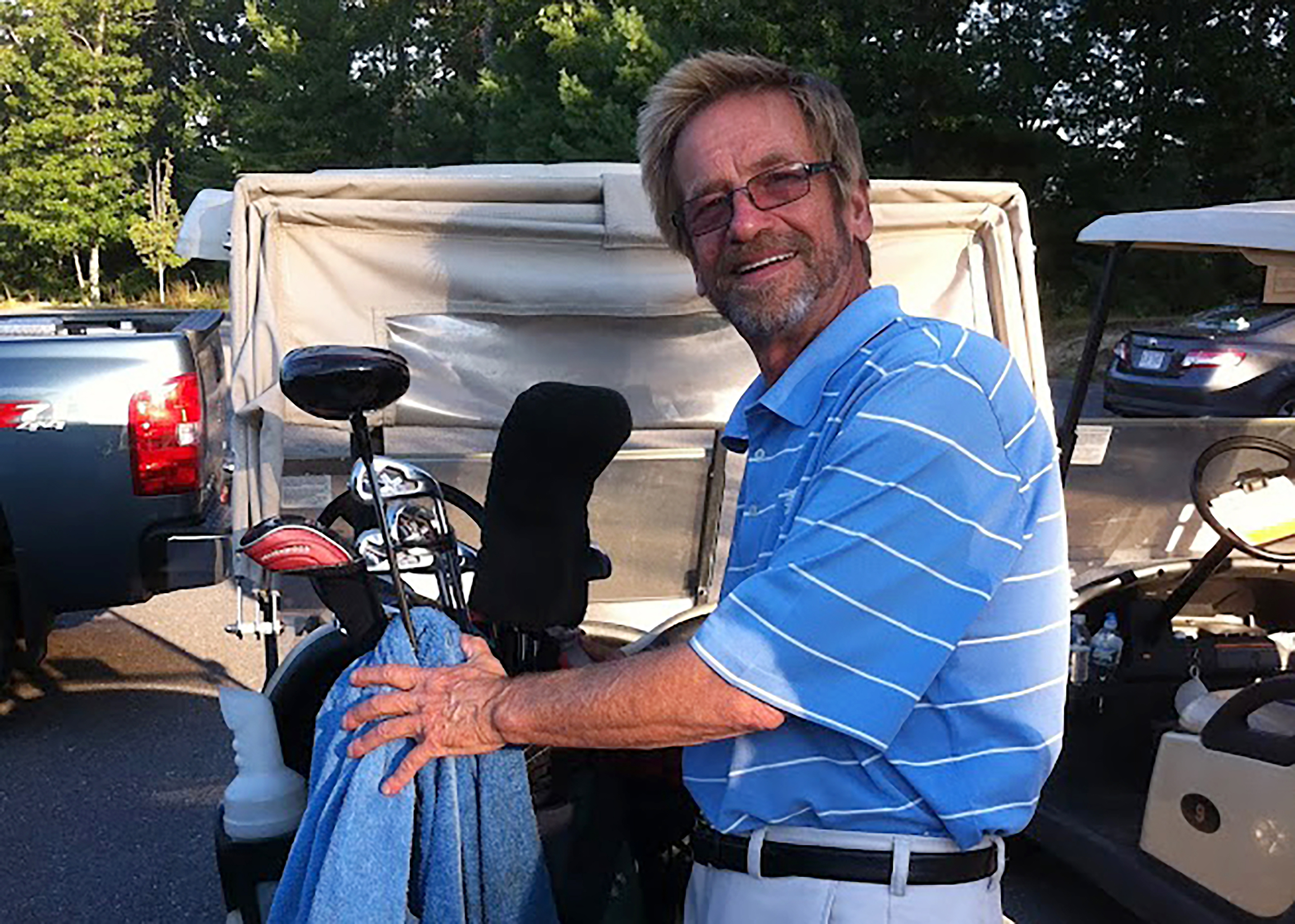 In this photo provided by Bob Van Wert, Tom Randele, whose real name according to authorities is Ted Conrad, tends to golf clubs, in September 2012, in Ayer, Mass. Conrad, a former Ohio bank teller-turned-thief, lived for decades under a different name in suburban Boston. Conrad died in May. 
