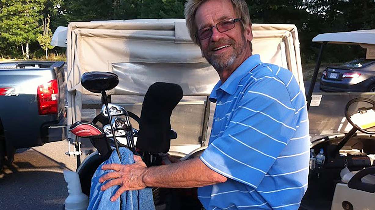 In this photo provided by Bob Van Wert, Tom Randele, whose real name according to authorities is Ted Conrad, tends to golf clubs, in September 2012, in Ayer, Mass. Conrad, a former Ohio bank teller-turned-thief, lived for decades under a different name in suburban Boston. Conrad died in May.