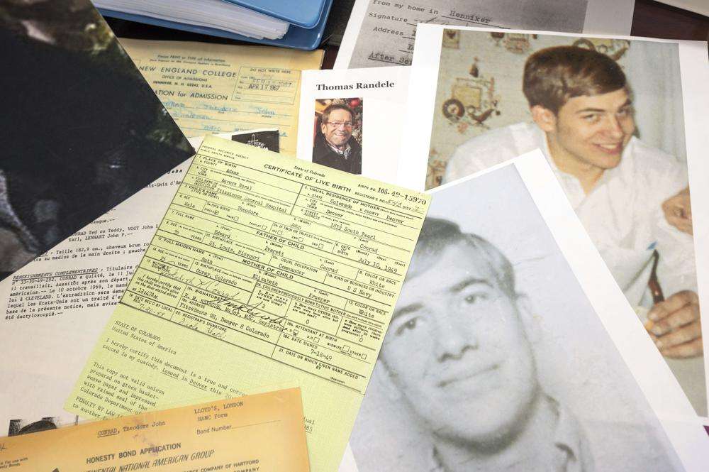 Photos, a driver's license, a death notice and other items from a 1969 robbery involving Ted Conrad are shown on Dec. 16, 2021 at the Carl B. Stokes U.S. Courthouse in Cleveland.