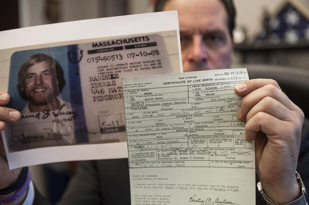U.S. Marshal Peter J. Elliott holds the birth certificate and a copy of the driver's license of Ted Conrad on Dec. 16, 2021 at the Carl B. Stokes U.S. Courthouse in Cleveland.