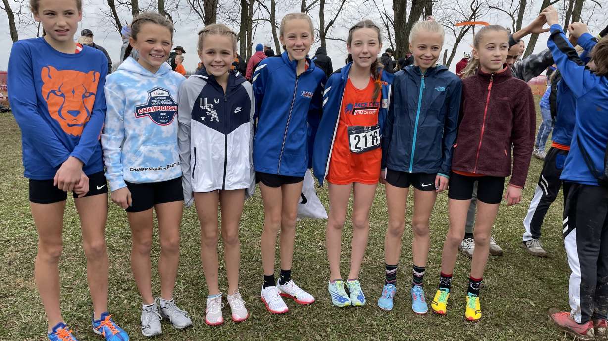 The National Championship cross-country team poses for a picture at the national meet. From left to right: Adria Favero, Tyana Lake, Teagan Harris, May Bybee, Lily Jameson, Hadley Flach and Tatum Flach.