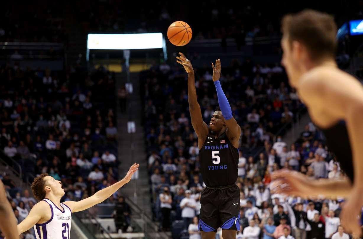Brigham Young forward Gideon George (5) drains a 3-point shot as BYU and Westminster play at the Marriott Center in Provo on Wednesday, Dec. 29, 2021. BYU won 65-53.
