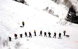 Rescuers search Dec. 27, 2003, for three young Utah men buried in an avalanche. In areas, snow depth of the avalanche field reached 36 feet.