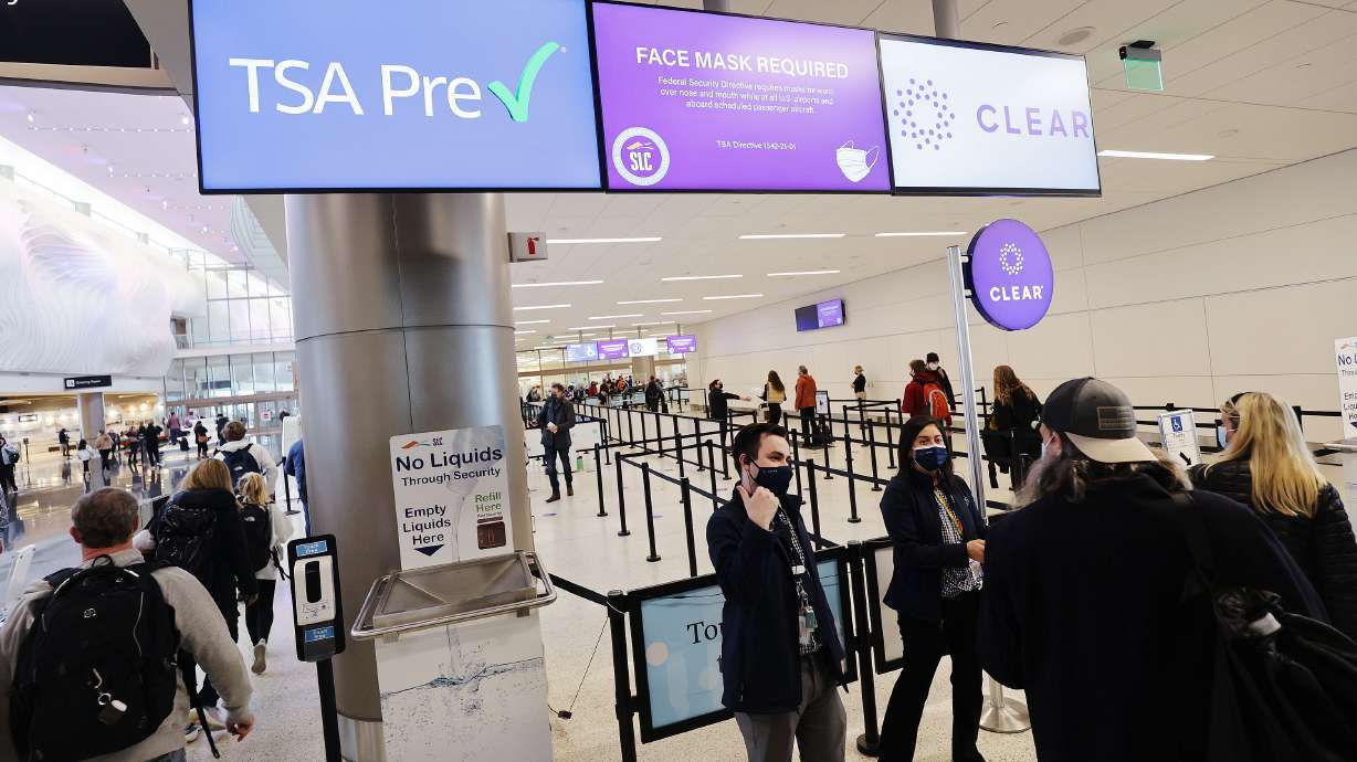 Travelers enter security at Salt Lake City International Airport on Dec. 22, 2021. A Utah woman has been charged with wire fraud and accused of selling fake COVID-19 tests to travelers at the airport.