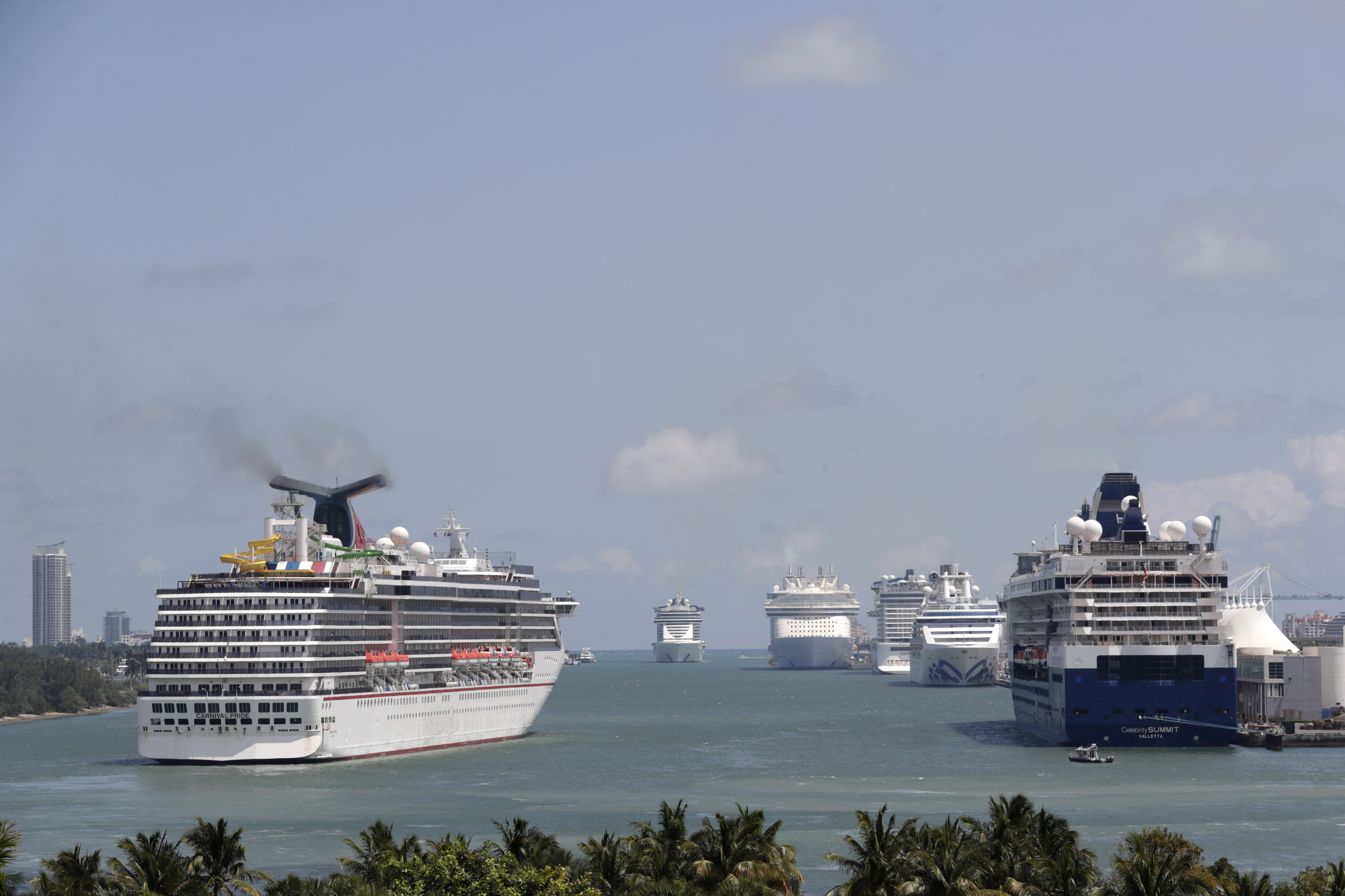 Cruise ships float at PortMiami, on April 7, 2020, in Miami. The U.S. Centers for Disease Control and Prevention is now warning people not to cruise regardless of their vaccination status because of an increase in cases fueled by the omicron variant detected in ships.
