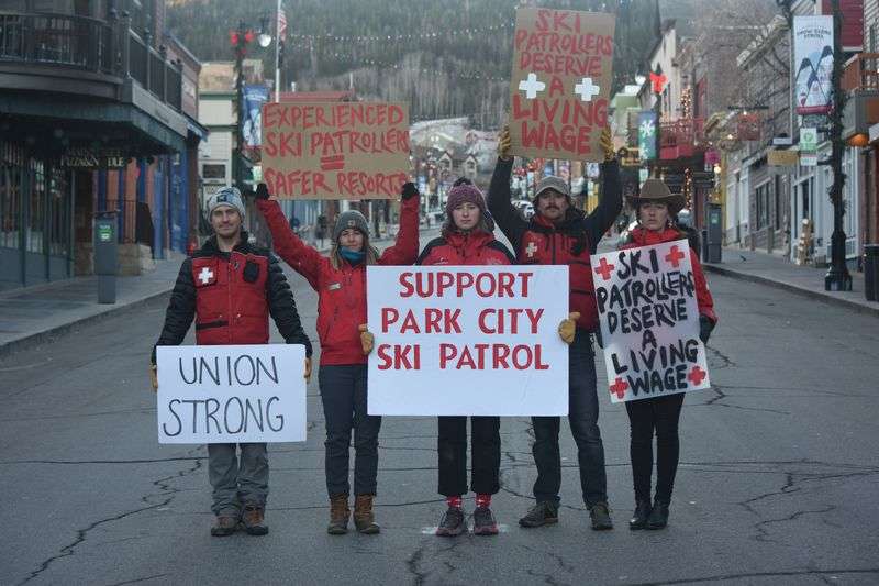In a photo provided by the Park City Professional Ski
Patrol Association, members Tyler Grundstrom, Kate Foley, Lee
Moriarty, Emmet Murray and Katie Woodward pose for a photo on Park
City’s Main Street while advocating for higher wages.