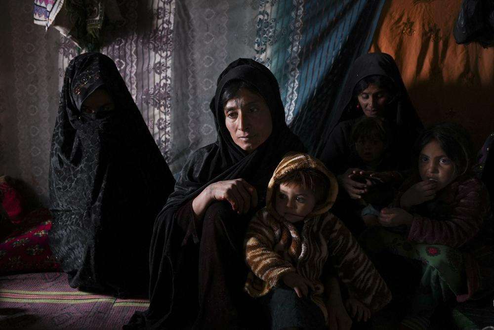 Guldasta and family members gather in their house at a settlement near Qala-e-Naw, Afghanistan, Dec. 14.