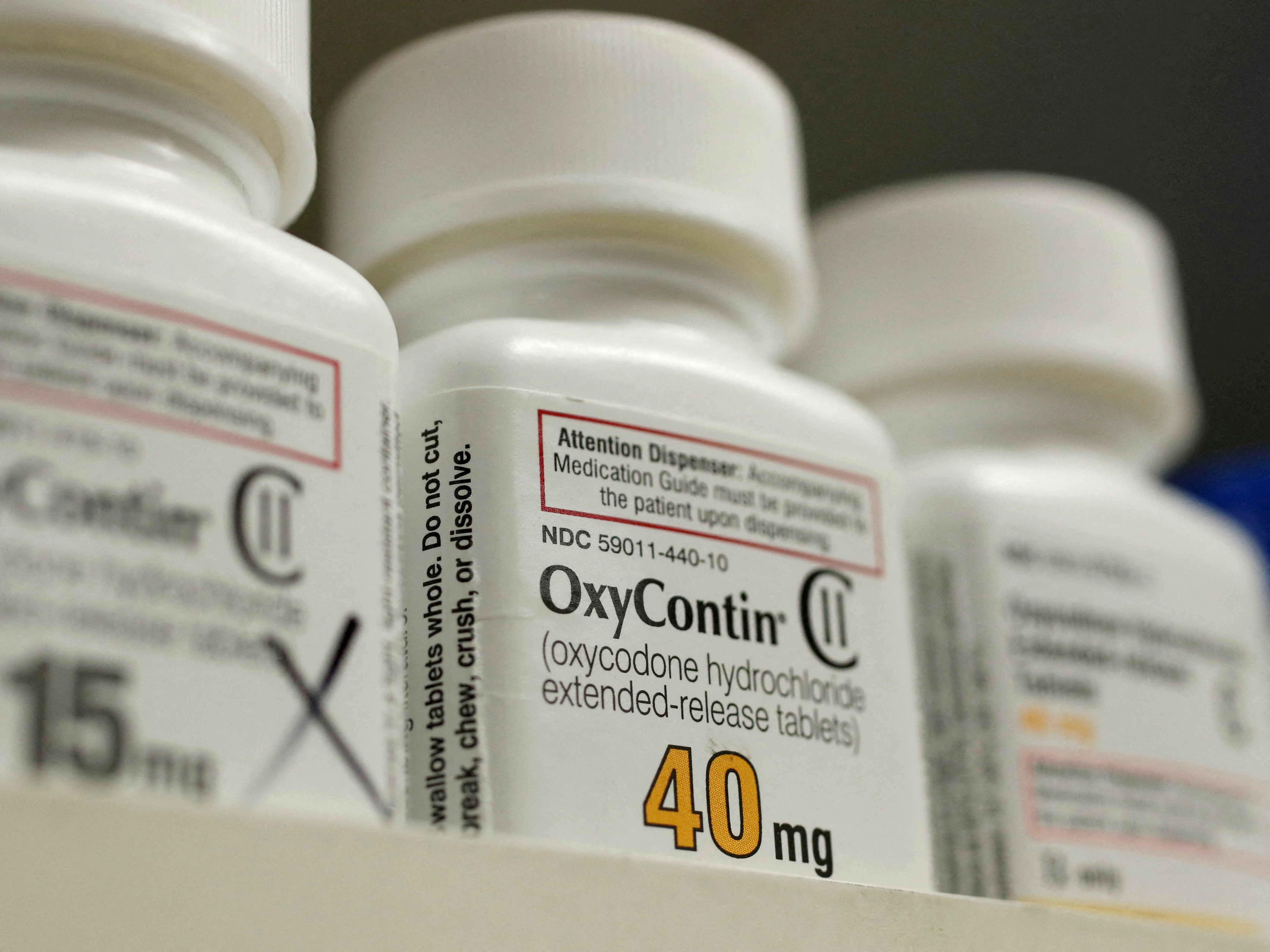 Bottles of prescription painkiller OxyContin made by Purdue Pharma L.D. sit on a shelf at a pharmacy in Provo on April 25, 2017. 