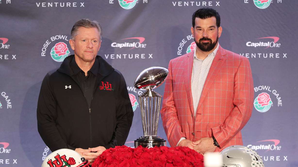 Utah Utes head coach Kyle Whittingham, left, and Ohio State Buckeyes head coach Ryan Day pose with the Rose Bowl trophy during a press conference in Los Angeles on Friday, Dec. 31, 2021.