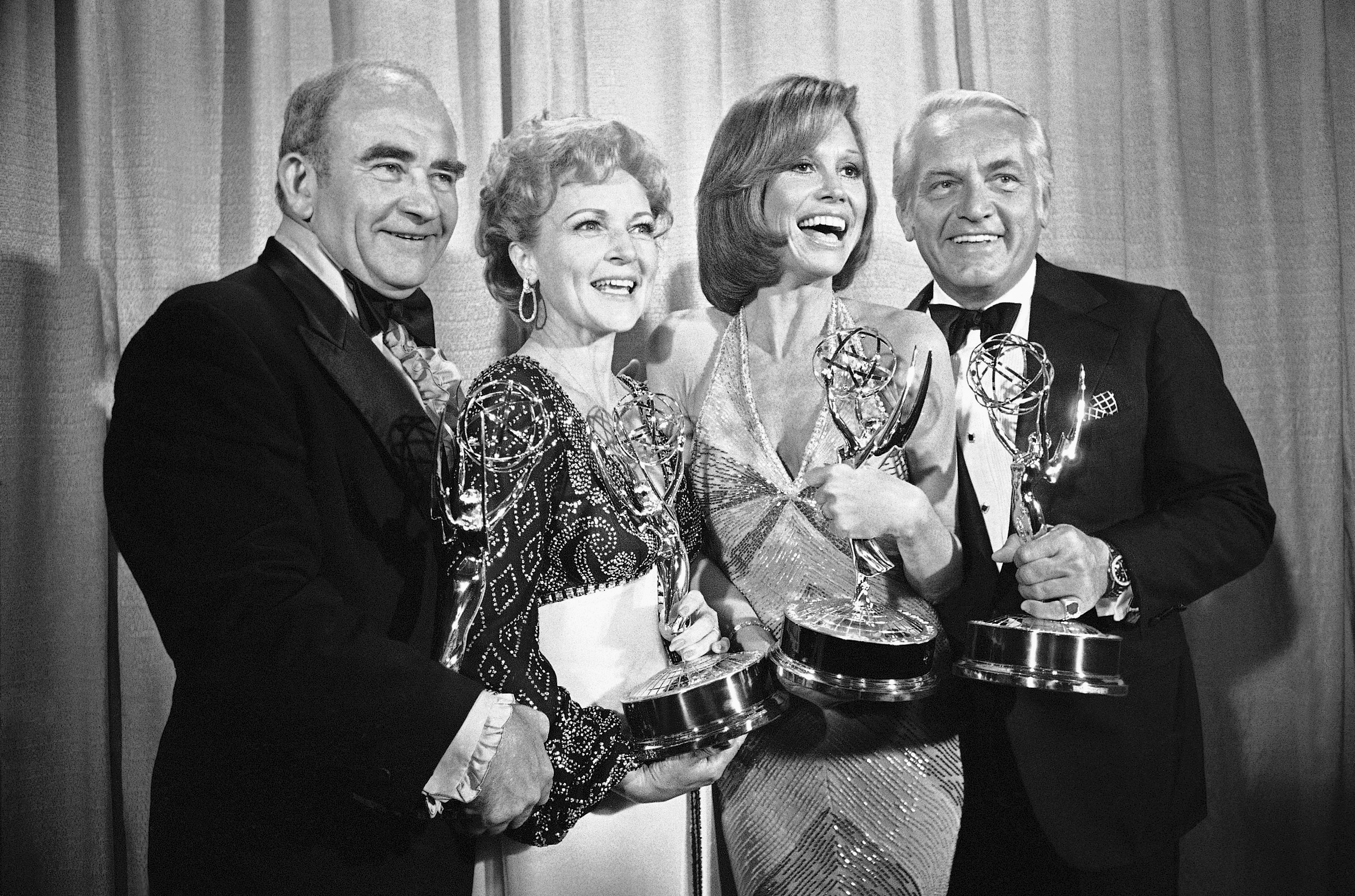 Cast members of the "Mary Tyler Moore Show," Ed Asner, Betty White, Mary Tyler Moore and Ted Knight, pose with their Emmys backstage at the 28th annual Emmy Awards in Los Angeles. Director James Burrows, who died on Friday at age 85, had a hand in directing the show to its artistic heights.