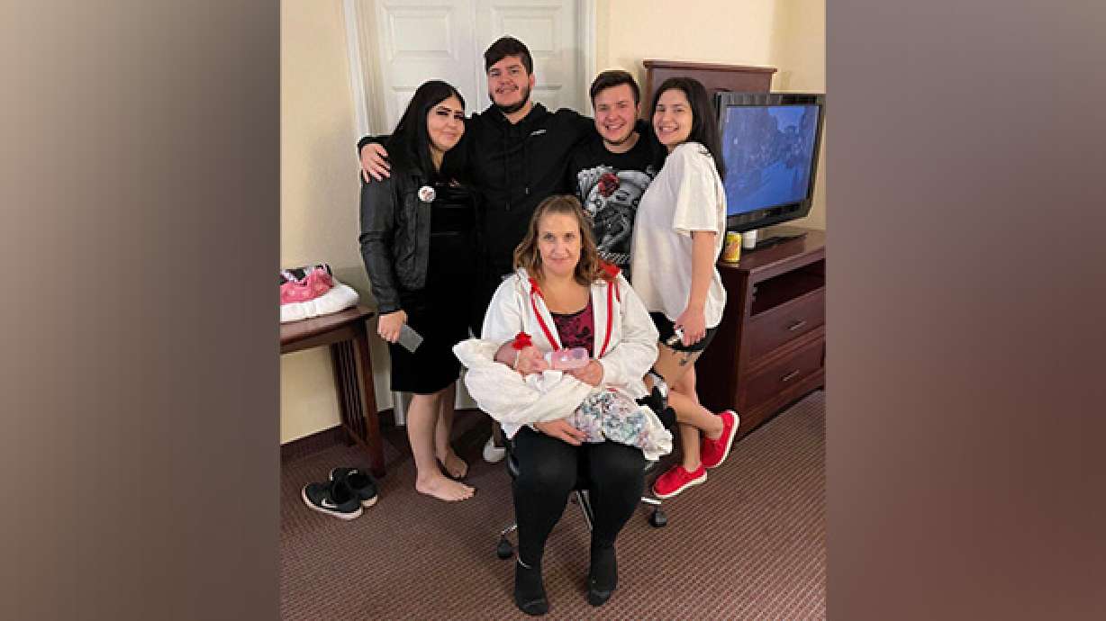 Elizabeth Apadaca Valdez holds her grandchild backed by her four children. Valdez died in a car crash on Christmas Eve.