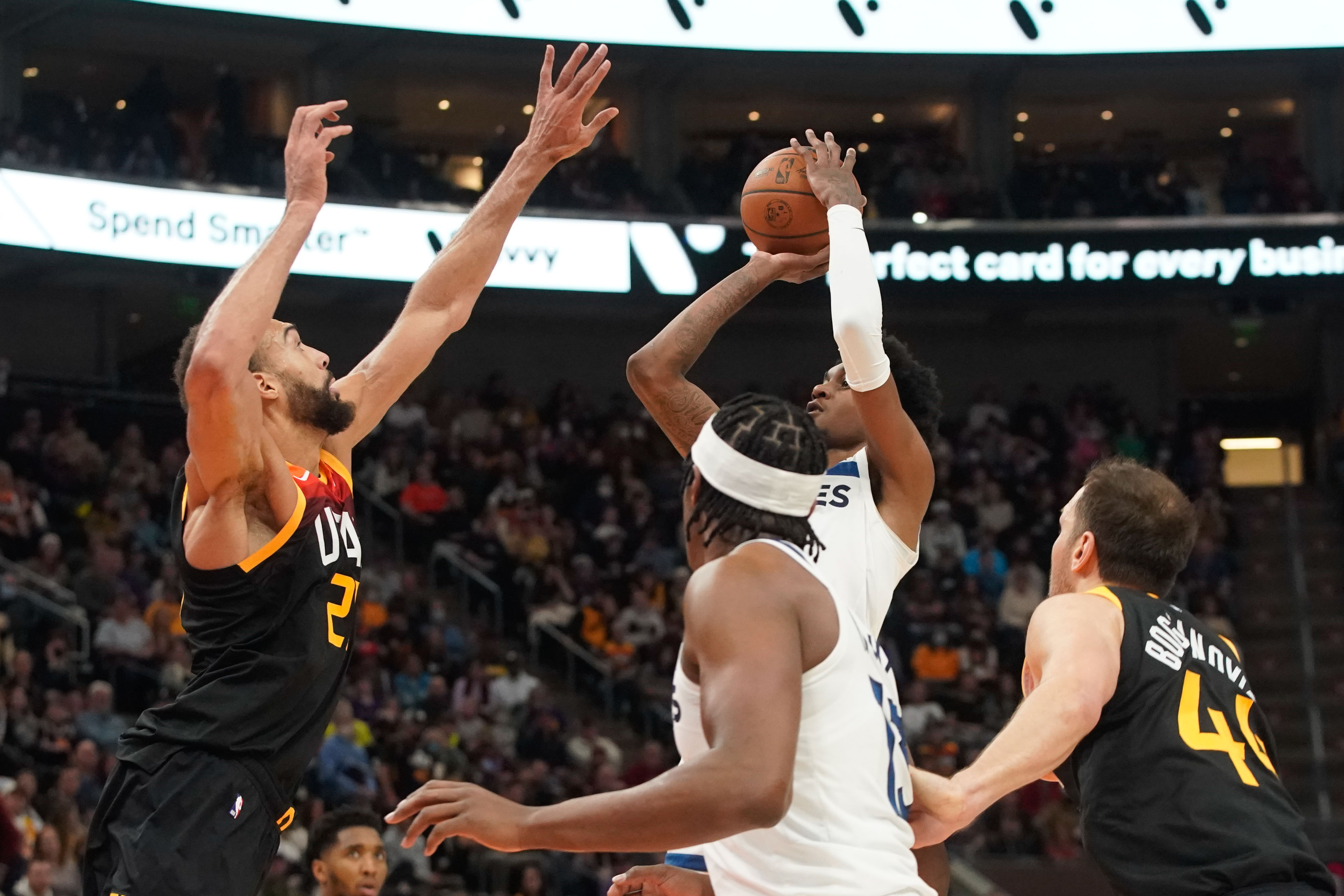 Minnesota Timberwolves forward Jaden McDaniels, right, attempts to shoot as Utah Jazz center Rudy Gobert attempts to block during an NBA game at Vivint Arena in Salt Lake City on Friday, Dec. 31, 2021.