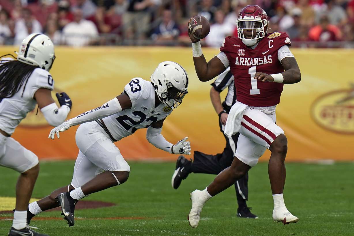 Arkansas quarterback KJ Jefferson (1) eludes Penn State linebacker Curtis Jacobs (23) during the first half of the Outback Bowl NCAA college football game Saturday, Jan. 1, 2022, in Tampa, Fla.