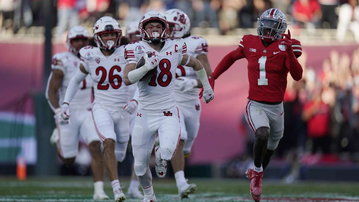 Utah wide receiver Britain Covey (18) returns a kick-off for a touchdown past Ohio State cornerback Demario McCall (1) during the first half in the Rose Bowl NCAA college football game Saturday, Jan. 1, 2022, in Pasadena, Calif.