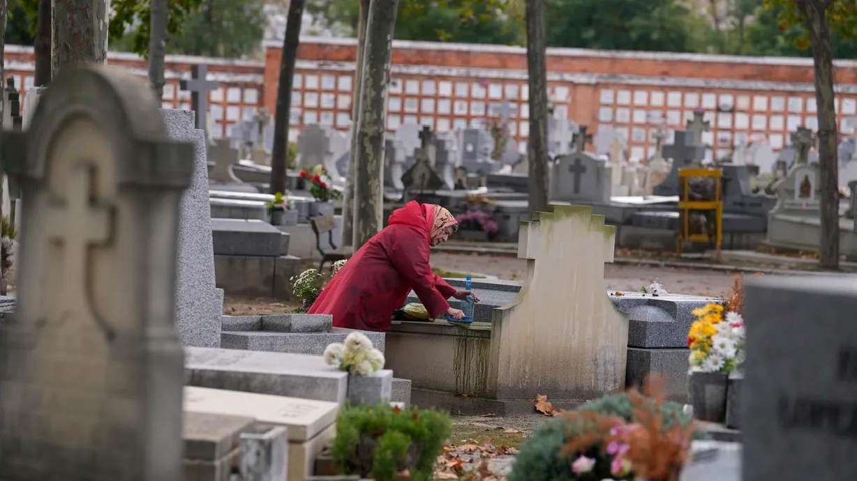 A woman cleans a relative’s tombstone in the Almudena cemetery a day before All Saints Day, a Catholic holiday to reflect on the saints and deceased relatives, in Madrid, Spain, Sunday, Oct. 31, 2021.