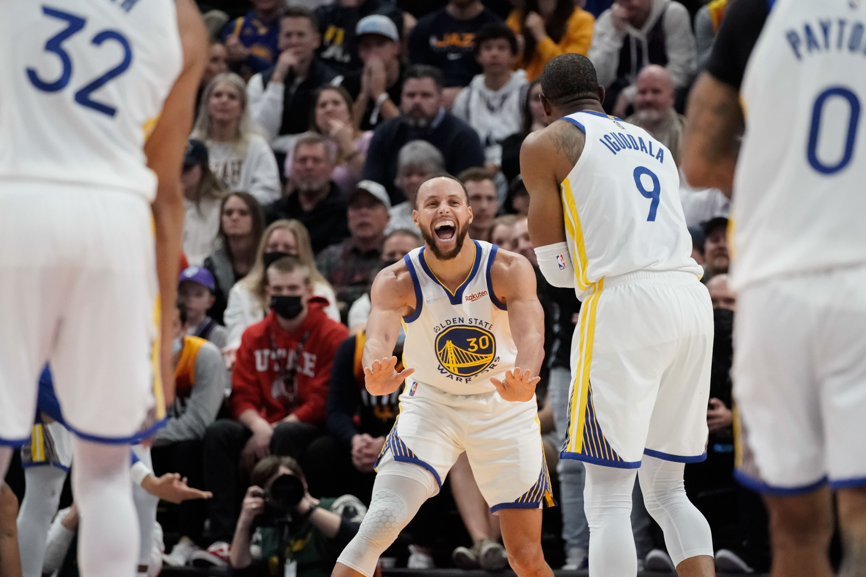 Golden State Warriors guard Stephen Curry (30) and forward Andre Iguodala celebrate a 3-pointer during an NBA game against Utah Jazz at Vivint Arena in Salt Lake City on Saturday, Jan. 1, 2022.
