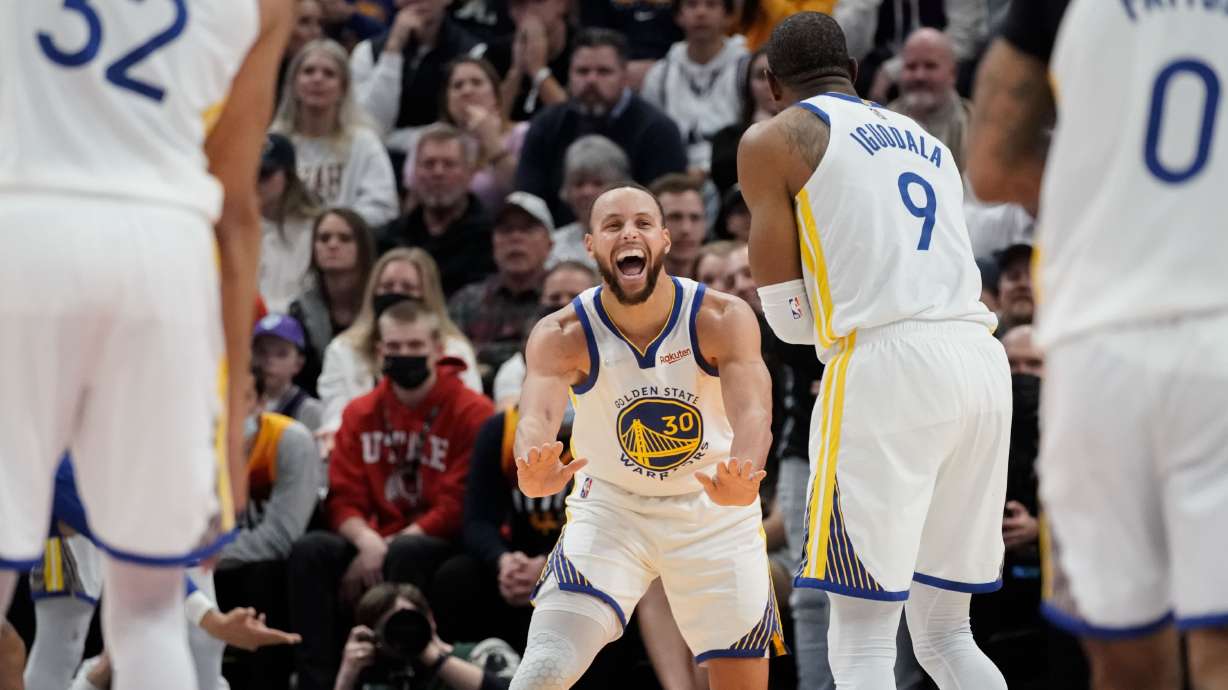 Golden State Warriors guard Stephen Curry (30) and forward Andre Iguodala celebrate a 3-pointer during an NBA game against Utah Jazz at Vivint Arena in Salt Lake City on Saturday, Jan. 1, 2022.