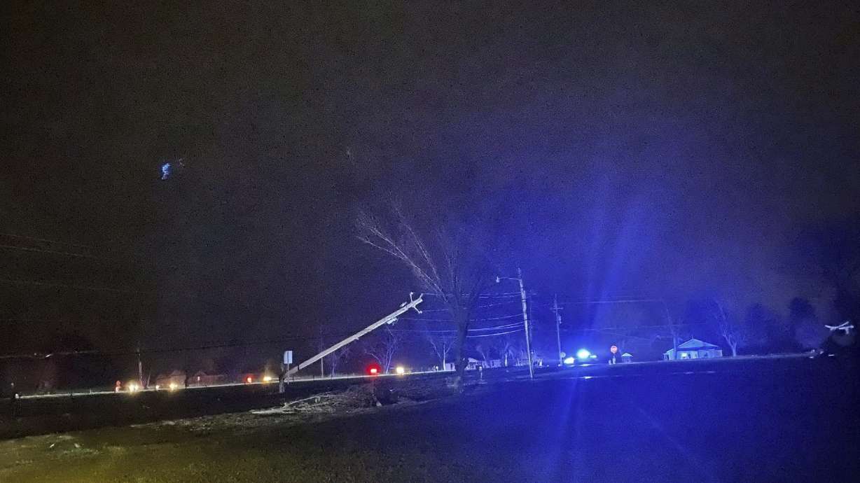 This photo provided by Madison County Sheriff's Office, authorities closed down a road after power lines came down and homes suffered damage early Sunday in Hazel Green, Ala. The storms followed a system earlier Saturday which brought a possible tornado and flooding to parts of Kentucky.