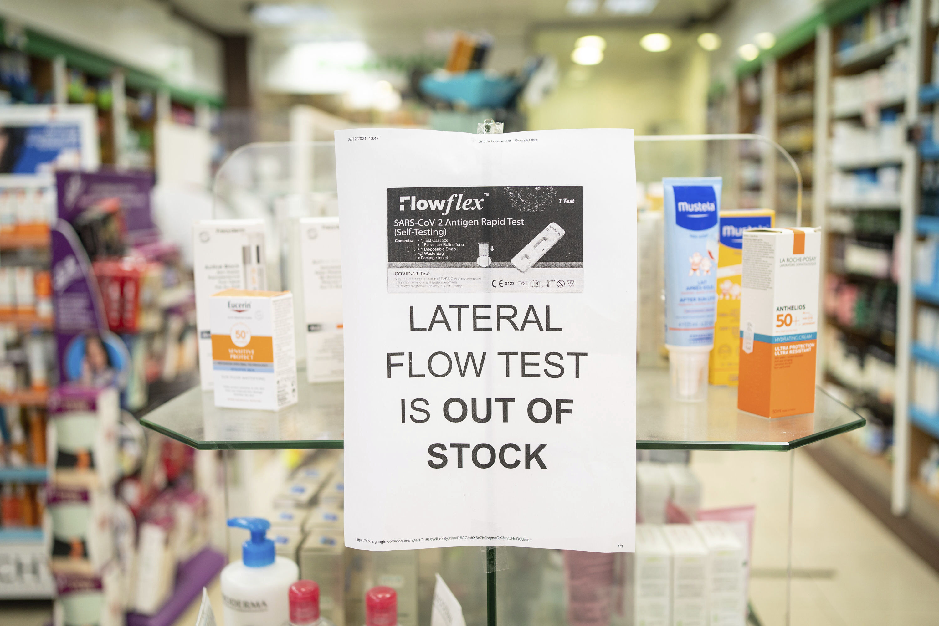 A sign saying lateral flow coronavirus tests are out of stock is displayed in a pharmacy window in London on Thursday.