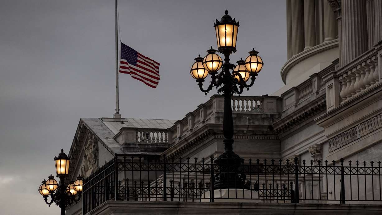 The flag flies at half-staff at the U.S. Capitol in Washington, Wednesday evening, to honor longtime Senate Majority Leader Harry Reid of Nevada who died Tuesday.