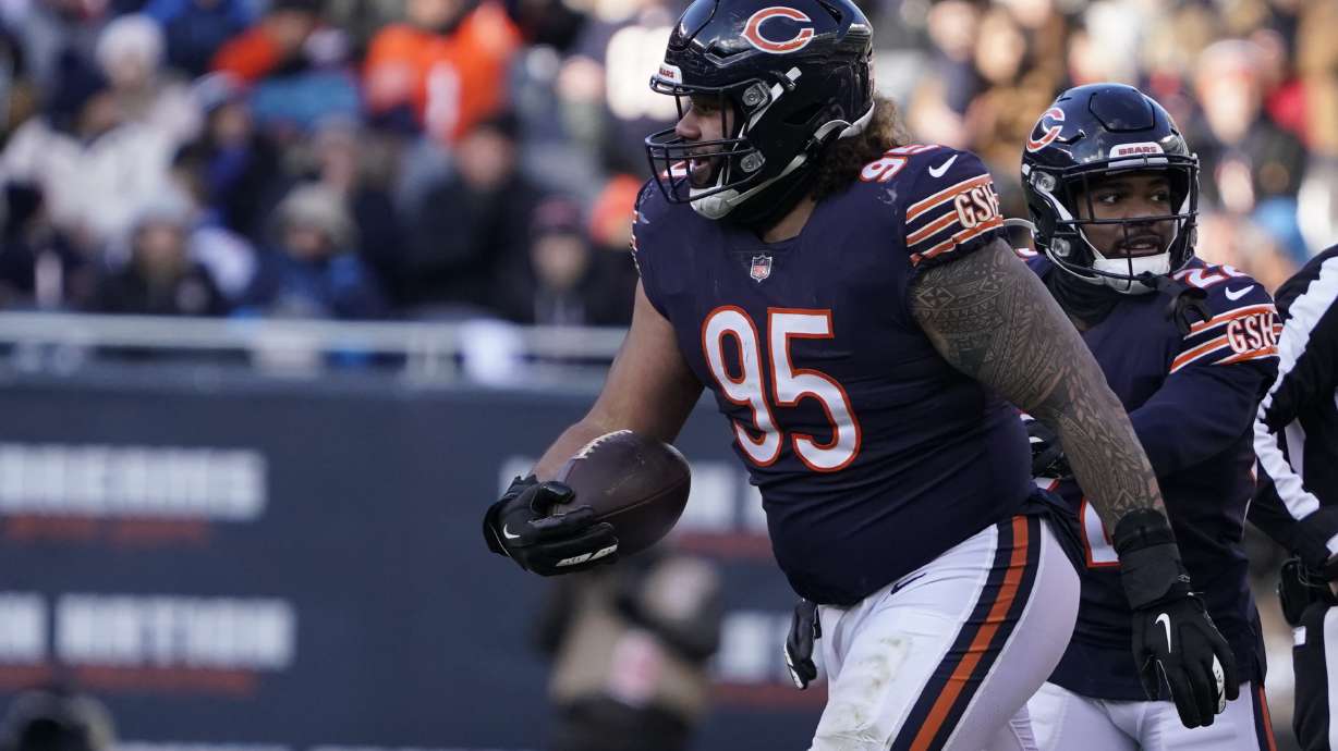 Chicago Bears nose tackle Khyiris Tonga celebrates his fumble recovery during the second half of an NFL football game Sunday, Jan. 2, 2022, in Chicago.