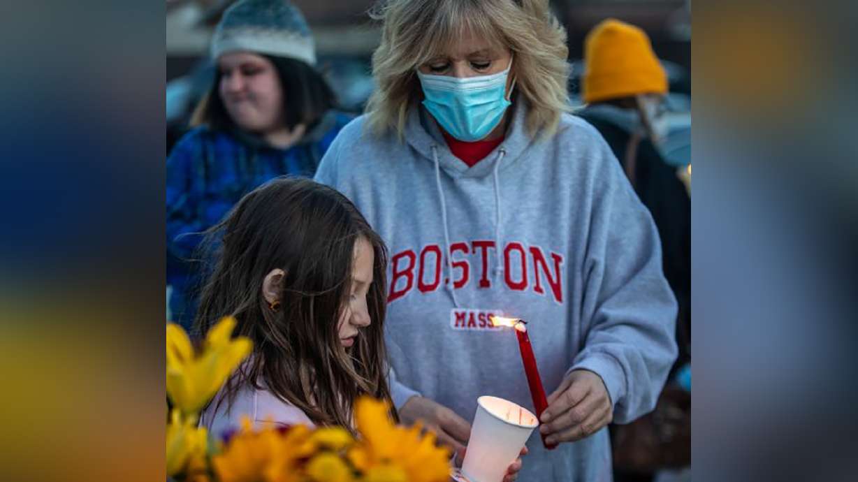 Rebecca Ortiz Calderon, Alonso Garcia-Mendoza's mother, helps light a candle at a vigil for Garcia-Mendoza during a vigil outside of a Latter-Day Saints meetinghouse at 5305 W. 5400 South in Kearns on Sunday March 14, 2021. Garcia-Mendoza was shot and killed in the parking lot.