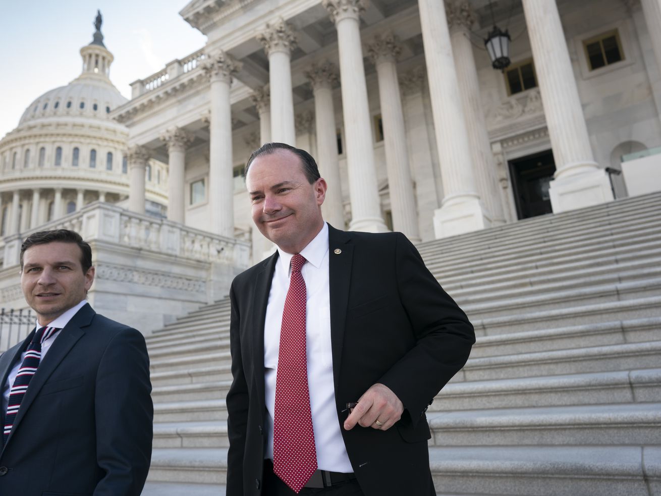 Sen. Mike Lee, R-Utah, right, leaves a private GOP lunch meeting at the Capitol in Washington, D.C., on Dec. 2.