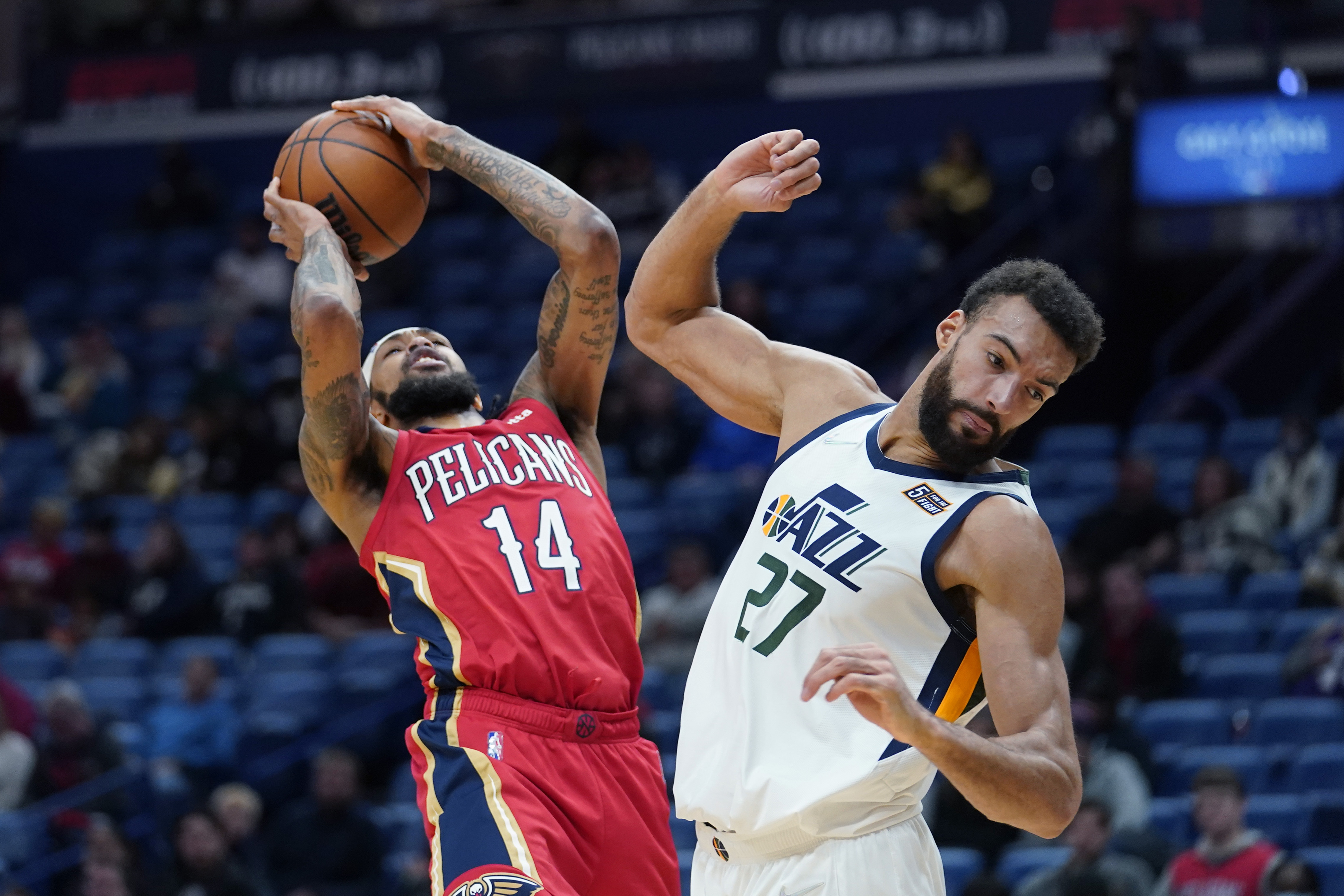 New Orleans Pelicans forward Brandon Ingram (14) shoots against Utah Jazz center Rudy Gobert (27) in the first half of an NBA basketball game in New Orleans, Monday, Jan. 3, 2022. 