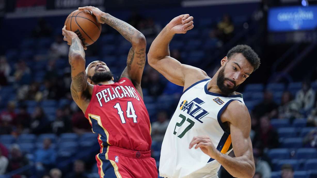 New Orleans Pelicans forward Brandon Ingram (14) shoots against Utah Jazz center Rudy Gobert (27) in the first half of an NBA basketball game in New Orleans, Monday, Jan. 3, 2022.