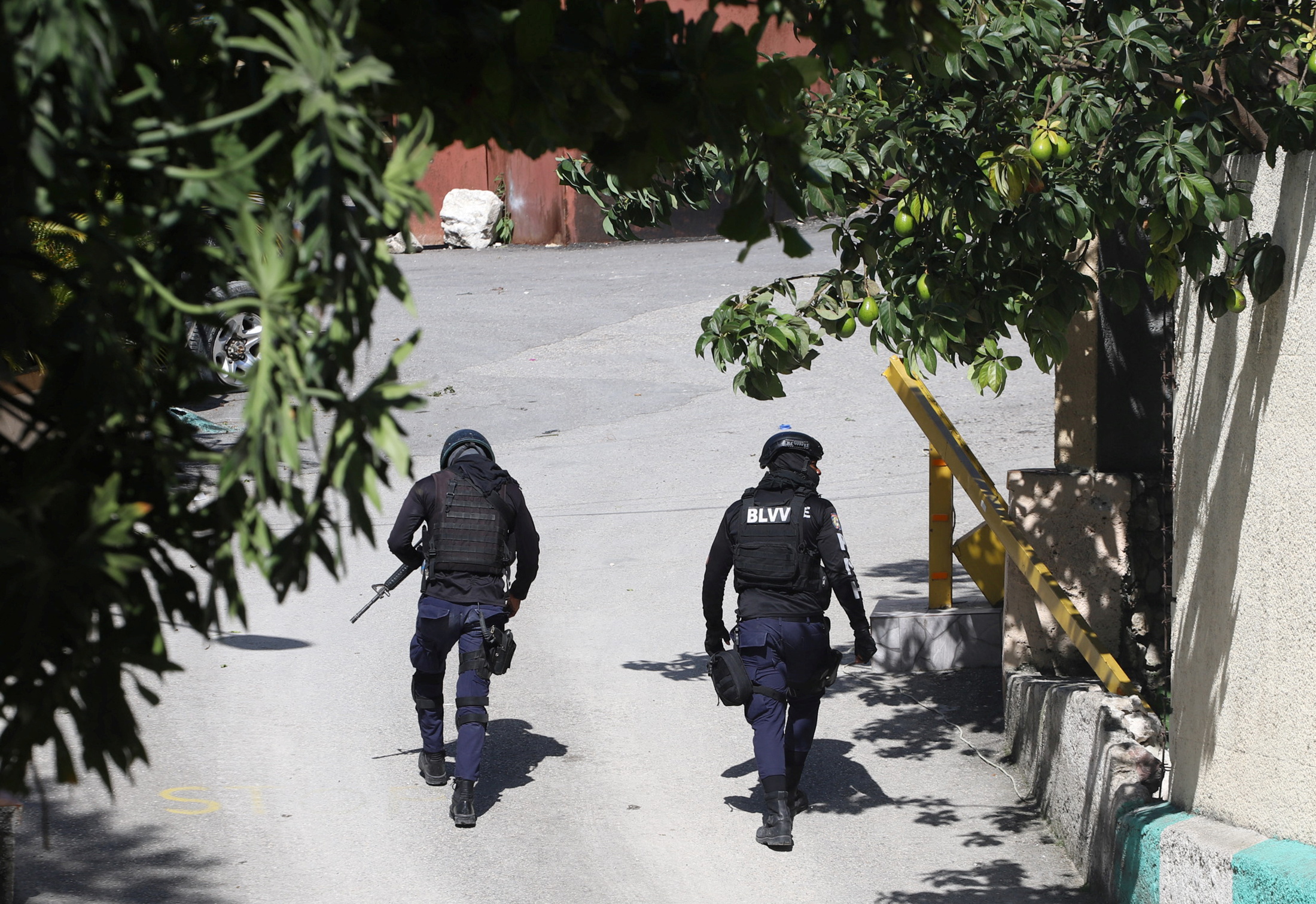 Police officers walk near the private residence of Haiti's President Jovenel Moise after he was shot dead by gunmen with assault rifles, in Port-au-Prince, Haiti July 7, 2021.