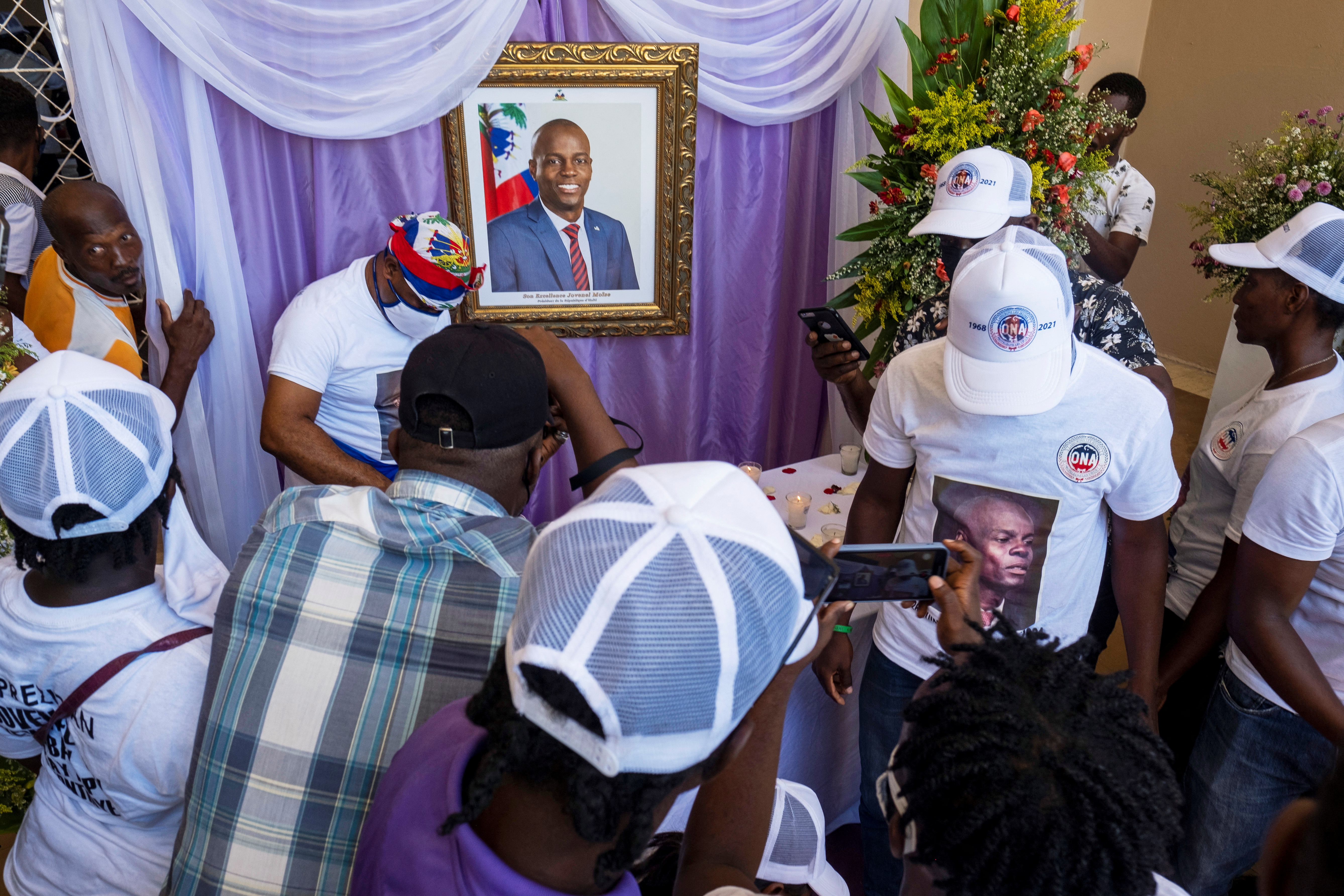 People attend a memorial for slain Haitian President Jovenel Moise at the city hall in Cap-Haitien, Haiti on July 22, 2021.