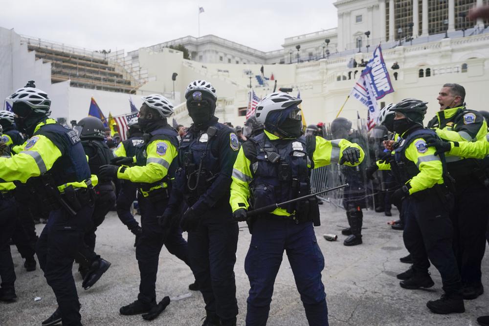 Washington Metropolitan Police department officers assist U.S. Capitol Police with rioters on the West Front of the U.S. Capitol on Jan. 6, 2021, in Washington.