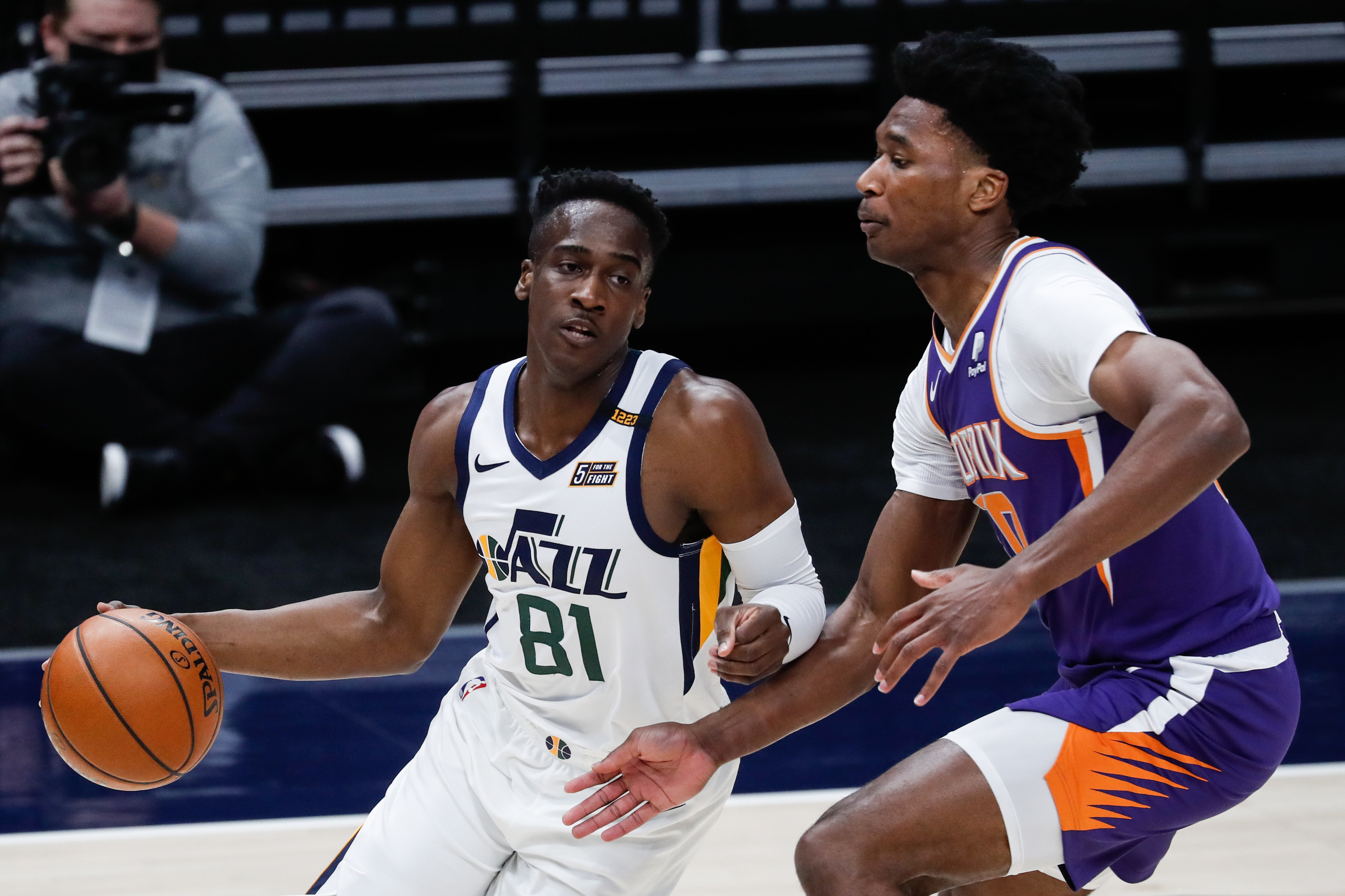 Utah Jazz guard Miye Oni (81) dribbles against Phoenix Suns center Damian Jones (30) during an NBA preseason game at Vivint Smart Home Arena in Salt Lake City on Saturday, Dec. 12, 2020.