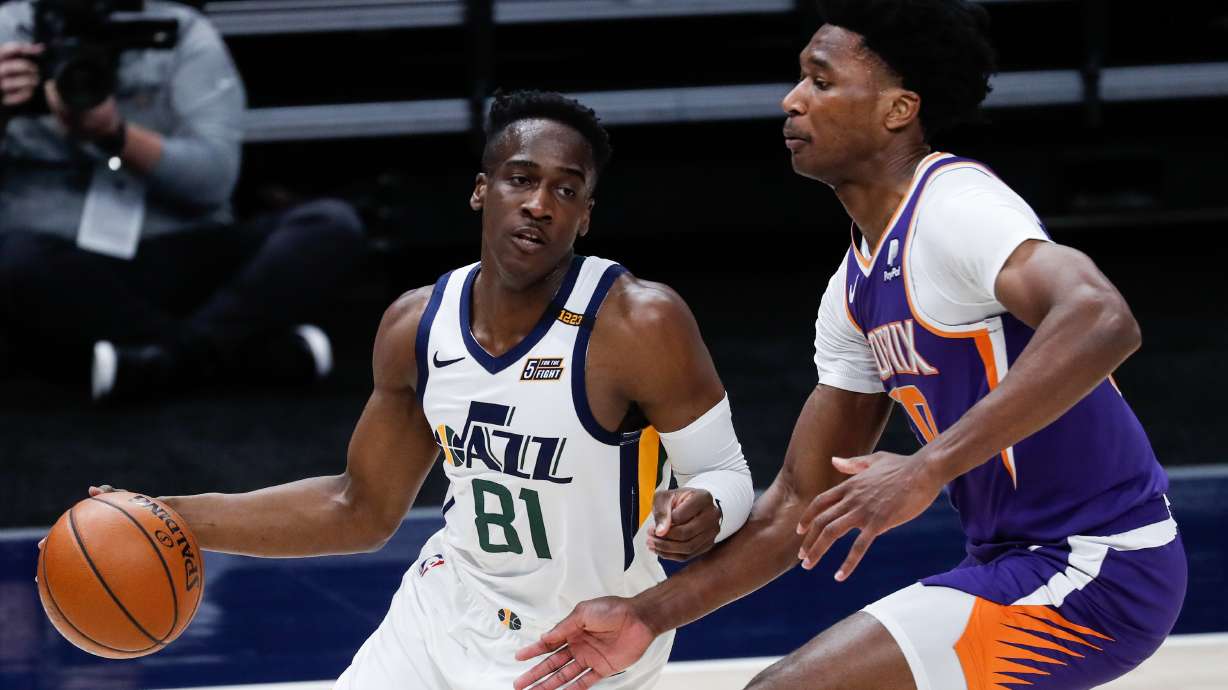 Utah Jazz guard Miye Oni (81) dribbles against Phoenix Suns center Damian Jones (30) during an NBA preseason game at Vivint Smart Home Arena in Salt Lake City on Saturday, Dec. 12, 2020.